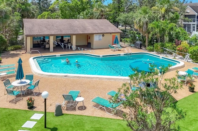3810 75th St W Unit 128, Bradenton, FL 34209 - community pool with a patio area and view of scattered trees