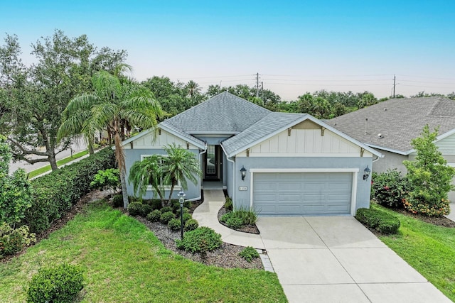 6516 Palm Leaf Ct, Sarasota, FL 34243 - ranch-style home featuring an attached garage, concrete driveway, a front yard, board and batten siding, and a shingled roof