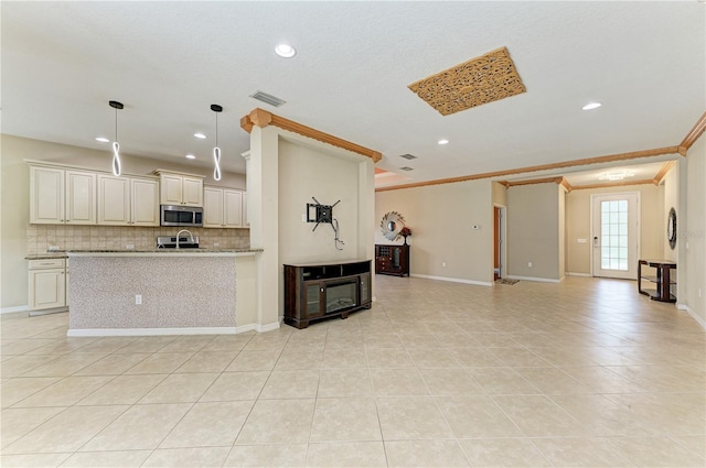 6516 Palm Leaf Ct, Sarasota, FL 34243 - kitchen with stainless steel microwave, open floor plan, tasteful backsplash, light tile patterned floors, and crown molding