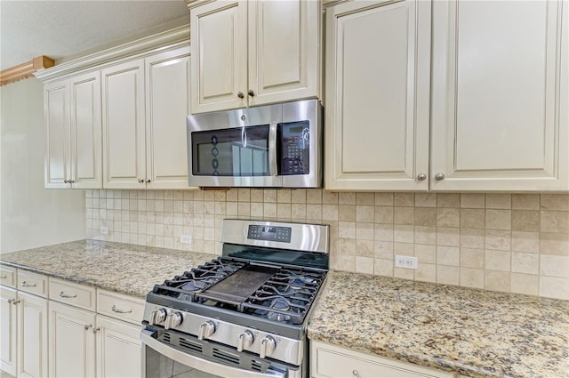 6516 Palm Leaf Ct, Sarasota, FL 34243 - kitchen with appliances with stainless steel finishes, tasteful backsplash, and light stone counters