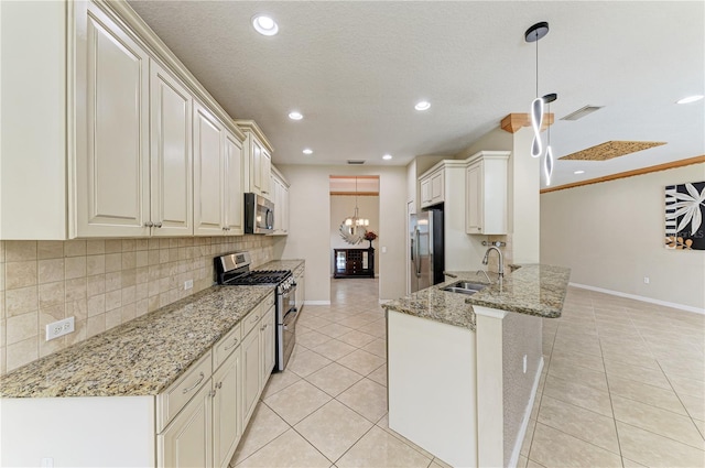 6516 Palm Leaf Ct, Sarasota, FL 34243 - kitchen with appliances with stainless steel finishes, light tile patterned floors, backsplash, a peninsula, and light stone countertops