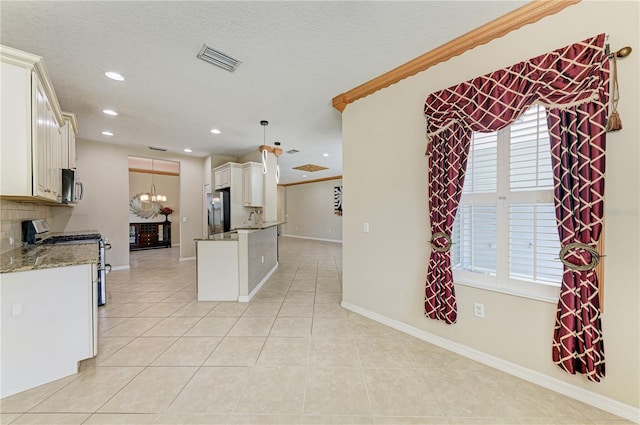 6516 Palm Leaf Ct, Sarasota, FL 34243 - kitchen with stainless steel appliances, light tile patterned floors, light stone counters, recessed lighting, and healthy amount of natural light