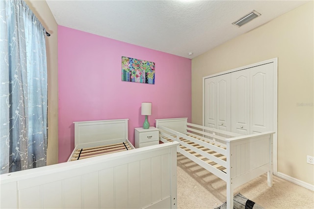 6516 Palm Leaf Ct, Sarasota, FL 34243 - carpeted bedroom with a closet and a textured ceiling