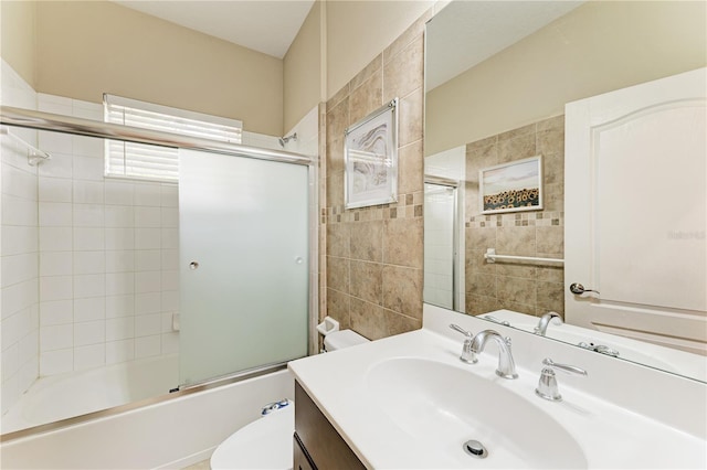 6516 Palm Leaf Ct, Sarasota, FL 34243 - bathroom featuring vanity, combined bath / shower with glass door, and tile walls