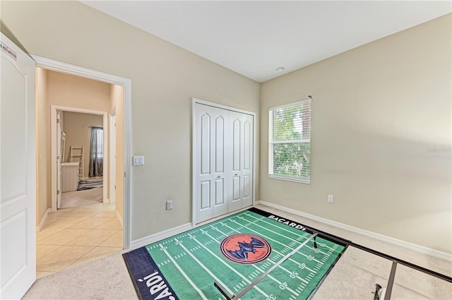 6516 Palm Leaf Ct, Sarasota, FL 34243 - unfurnished bedroom with light colored carpet, a closet, and light tile patterned floors