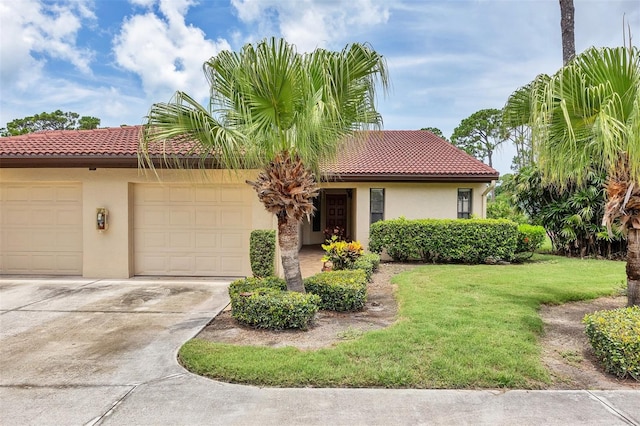 3617 Yellow Pine Ct Unit 144, Sarasota, FL 34238 - view of front of home featuring a tile roof, an attached garage, concrete driveway, stucco siding, and a front lawn