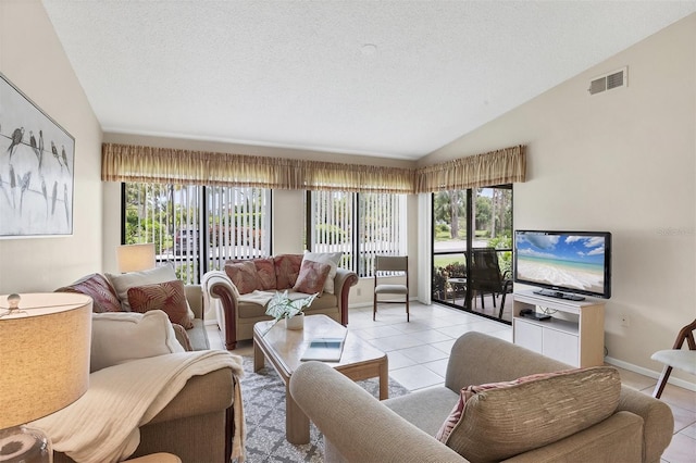3617 Yellow Pine Ct Unit 144, Sarasota, FL 34238 - living room with light tile patterned flooring, lofted ceiling, healthy amount of natural light, and a textured ceiling