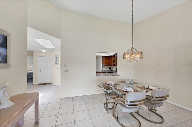 3617 Yellow Pine Ct Unit 144, Sarasota, FL 34238 - dining area with high vaulted ceiling, light tile patterned floors, a skylight, and a chandelier
