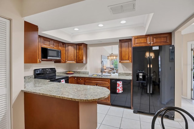 3617 Yellow Pine Ct Unit 144, Sarasota, FL 34238 - kitchen with black appliances, a tray ceiling, a peninsula, light tile patterned flooring, and recessed lighting