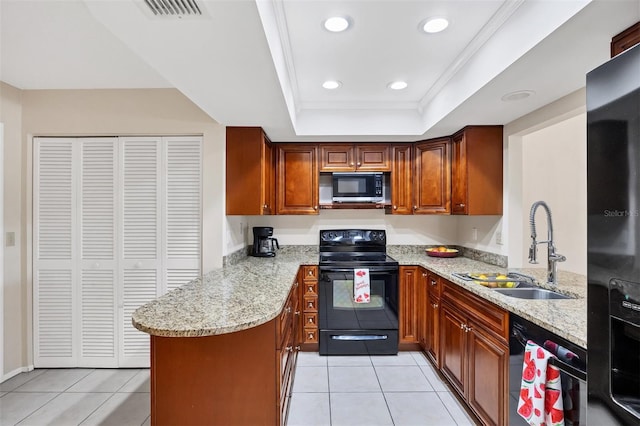 3617 Yellow Pine Ct Unit 144, Sarasota, FL 34238 - kitchen featuring black appliances, a peninsula, light tile patterned flooring, a raised ceiling, and light stone counters