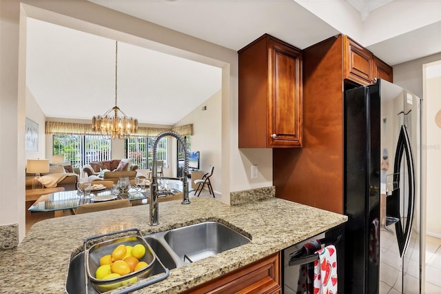 3617 Yellow Pine Ct Unit 144, Sarasota, FL 34238 - kitchen featuring black fridge, light stone countertops, a chandelier, open floor plan, and decorative light fixtures