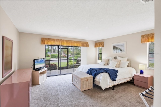 3617 Yellow Pine Ct Unit 144, Sarasota, FL 34238 - carpeted bedroom with access to exterior and a textured ceiling