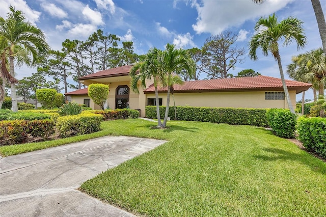 3617 Yellow Pine Ct Unit 144, Sarasota, FL 34238 - mediterranean / spanish house featuring a front yard, stucco siding, and a tiled roof