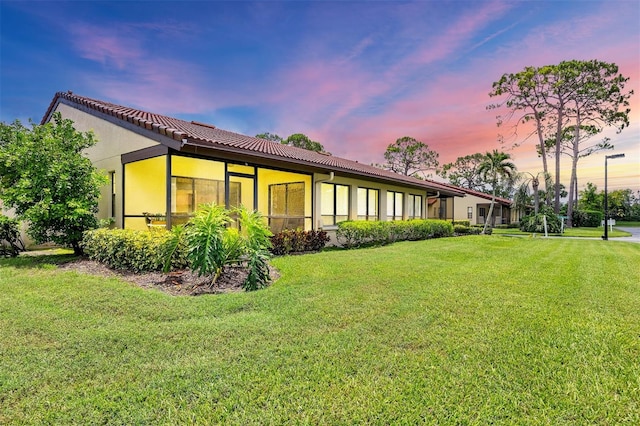 3617 Yellow Pine Ct Unit 144, Sarasota, FL 34238 - back of house with a lawn, stucco siding, and a tiled roof