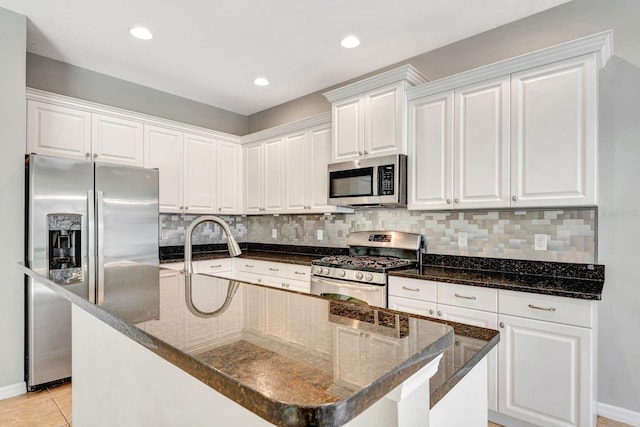 5005 Torrey Pines Run, Bradenton, FL 34211 - kitchen featuring stainless steel appliances, white cabinetry, backsplash, an island with sink, and recessed lighting