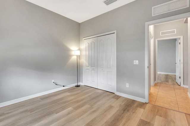 5005 Torrey Pines Run, Bradenton, FL 34211 - unfurnished bedroom featuring light wood finished floors and a closet