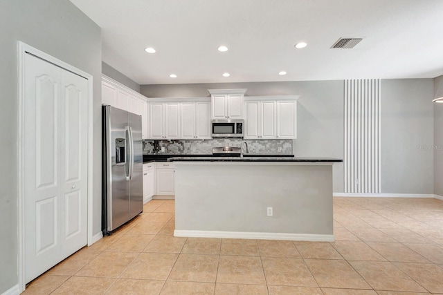 5005 Torrey Pines Run, Bradenton, FL 34211 - kitchen with appliances with stainless steel finishes, light tile patterned floors, backsplash, dark countertops, and recessed lighting