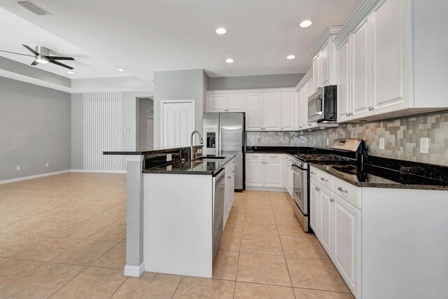 5005 Torrey Pines Run, Bradenton, FL 34211 - kitchen featuring appliances with stainless steel finishes, light tile patterned floors, decorative backsplash, white cabinets, and recessed lighting