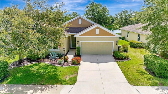 5005 Torrey Pines Run, Bradenton, FL 34211 - view of front of house with an attached garage, a front yard, driveway, and stucco siding