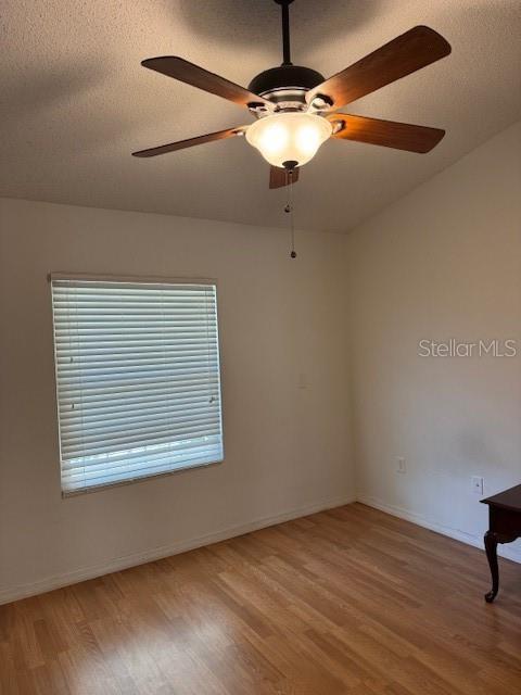 3404 56th Dr E, Bradenton, FL 34203 - empty room with wood finished floors, ceiling fan, and a textured ceiling
