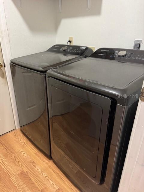 3404 56th Dr E, Bradenton, FL 34203 - washroom featuring washing machine and dryer and light wood-style flooring