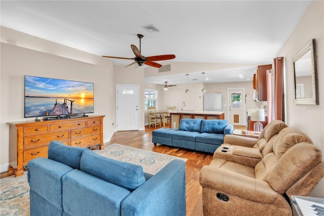 2218 Woodmere Rd, Venice, FL 34293 - living area featuring light wood finished floors, ceiling fan, and lofted ceiling