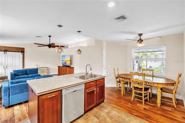 2218 Woodmere Rd, Venice, FL 34293 - kitchen with dishwasher, a ceiling fan, open floor plan, a barn door, and light countertops