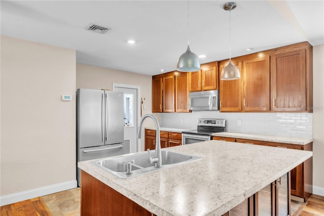 2218 Woodmere Rd, Venice, FL 34293 - kitchen featuring appliances with stainless steel finishes, tasteful backsplash, light countertops, hanging light fixtures, and recessed lighting