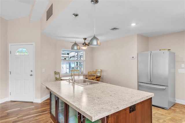 2218 Woodmere Rd, Venice, FL 34293 - kitchen featuring freestanding refrigerator, plenty of natural light, light countertops, and hanging light fixtures