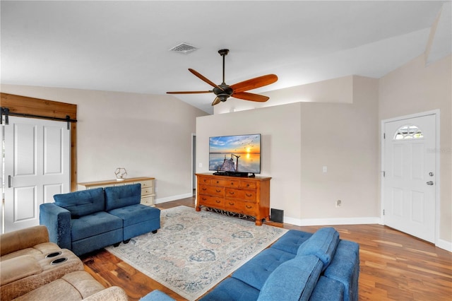 2218 Woodmere Rd, Venice, FL 34293 - living area featuring a ceiling fan, wood finished floors, and a barn door