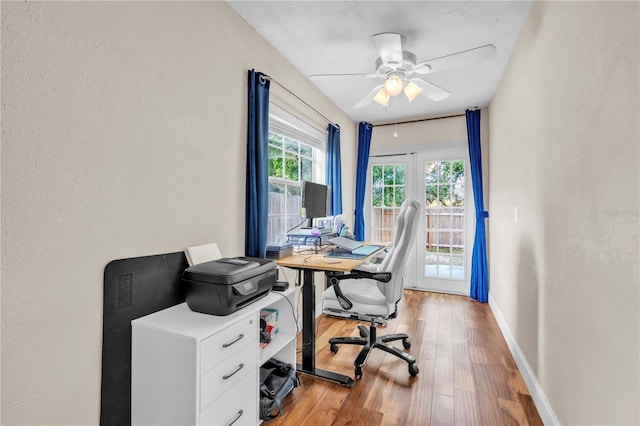 2218 Woodmere Rd, Venice, FL 34293 - office area with a ceiling fan, light wood-style flooring, and a textured wall