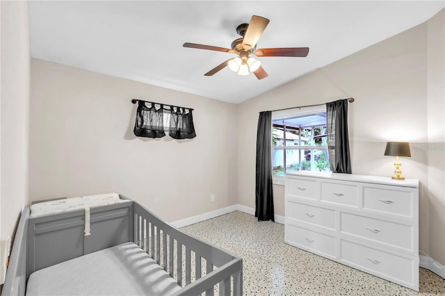 2218 Woodmere Rd, Venice, FL 34293 - bedroom featuring dark speckled floor, lofted ceiling, a nursery area, and a ceiling fan