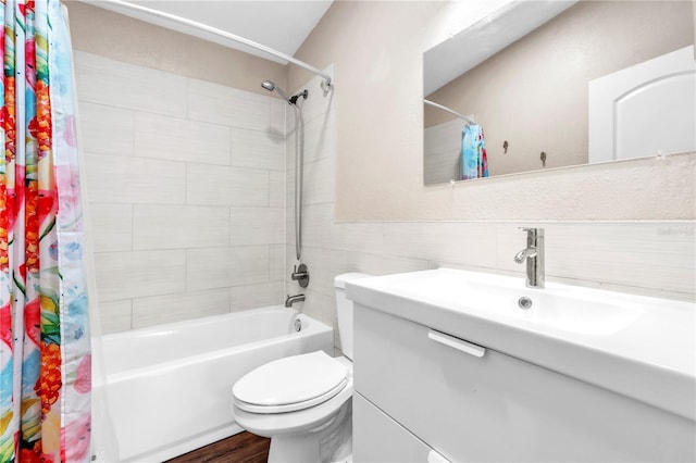 2218 Woodmere Rd, Venice, FL 34293 - bathroom featuring vanity, shower / tub combo with curtain, tile walls, and wood finished floors