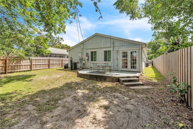 2218 Woodmere Rd, Venice, FL 34293 - rear view of house with french doors and a fenced backyard