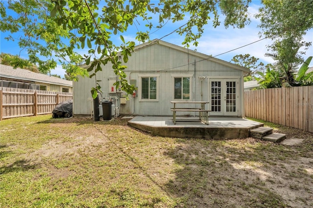 2218 Woodmere Rd, Venice, FL 34293 - back of house featuring french doors, a fenced backyard, and a patio