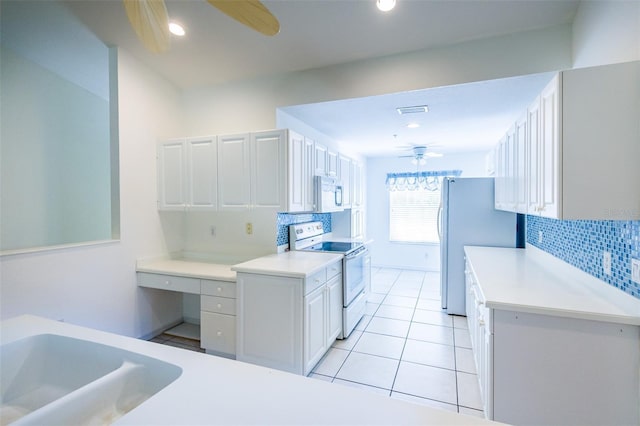 7137 Cedar Hollow Cir, Bradenton, FL 34203 - kitchen featuring white appliances, ceiling fan, backsplash, built in desk, and recessed lighting
