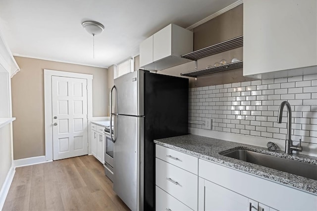 723 7th Ave N, Saint Petersburg, FL 33701 - kitchen featuring stainless steel appliances, open shelves, white cabinets, light stone counters, and decorative backsplash