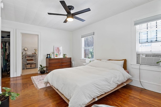723 7th Ave N, Saint Petersburg, FL 33701 - bedroom with wood finished floors, cooling unit, ceiling fan, and a closet
