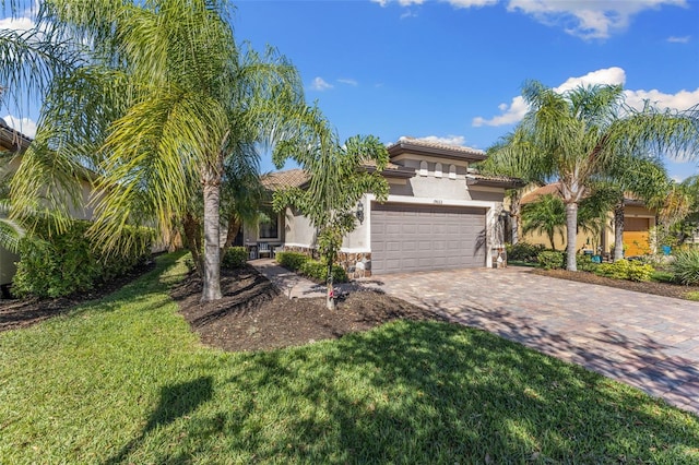 19023 Mangieri St, Venice, FL 34293 - mediterranean / spanish-style house featuring stucco siding, a tile roof, driveway, a front lawn, and a garage