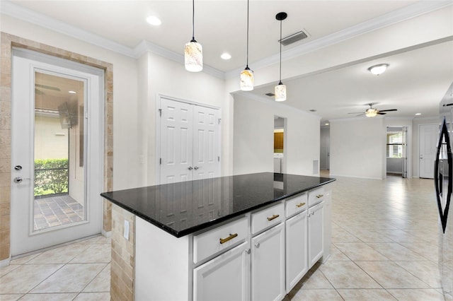 19023 Mangieri St, Venice, FL 34293 - kitchen featuring light tile patterned flooring, ornamental molding, white cabinets, a center island, and hanging light fixtures