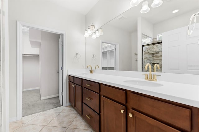19023 Mangieri St, Venice, FL 34293 - bathroom with double vanity, a spacious closet, a shower stall, and tile patterned flooring