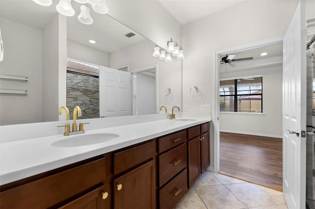 19023 Mangieri St, Venice, FL 34293 - bathroom with double vanity, tile patterned flooring, ceiling fan, and a tile shower