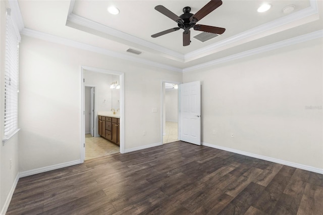 19023 Mangieri St, Venice, FL 34293 - unfurnished bedroom with a raised ceiling, wood finished floors, ornamental molding, recessed lighting, and connected bathroom