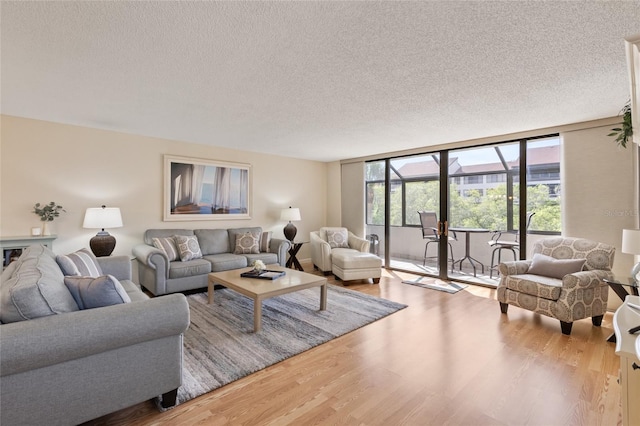 6265 Midnight Pass Rd Unit 205, Sarasota, FL 34242 - living room with a textured ceiling and wood finished floors