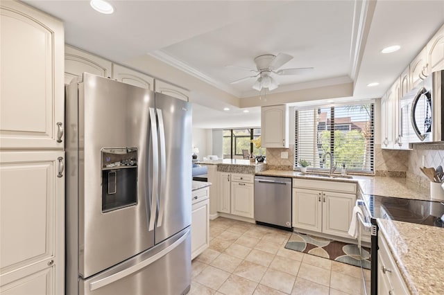 6265 Midnight Pass Rd Unit 205, Sarasota, FL 34242 - kitchen with stainless steel appliances, a tray ceiling, a ceiling fan, tasteful backsplash, and ornamental molding
