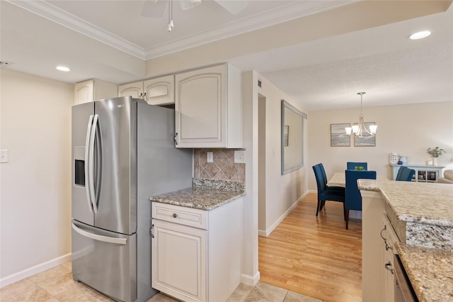 6265 Midnight Pass Rd Unit 205, Sarasota, FL 34242 - kitchen featuring stainless steel fridge, crown molding, backsplash, a chandelier, and pendant lighting