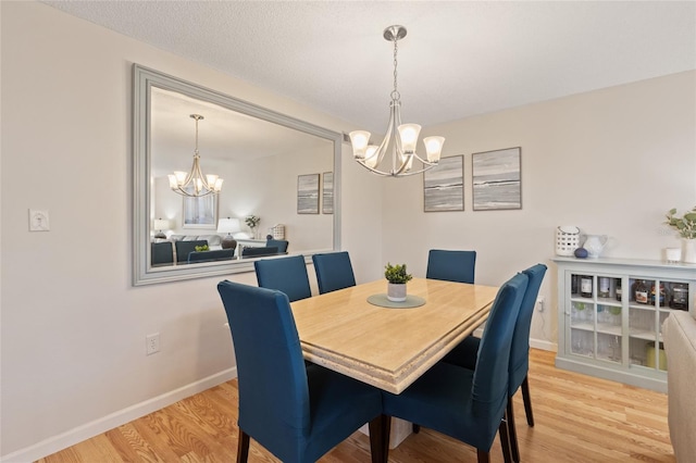 6265 Midnight Pass Rd Unit 205, Sarasota, FL 34242 - dining area with a chandelier and wood finished floors