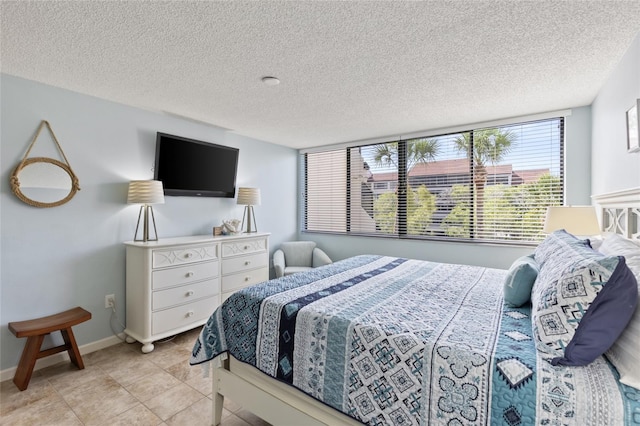 6265 Midnight Pass Rd Unit 205, Sarasota, FL 34242 - bedroom featuring a textured ceiling and light tile patterned floors