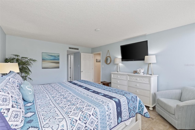 6265 Midnight Pass Rd Unit 205, Sarasota, FL 34242 - tiled bedroom featuring a textured ceiling