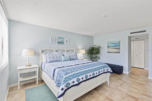 6265 Midnight Pass Rd Unit 205, Sarasota, FL 34242 - bedroom with a textured ceiling and multiple windows